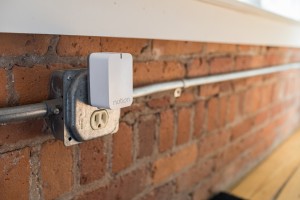 Sensors throughout the home send signals to a Wi-Fi connected plug-in that forwards messages to smartphones. 