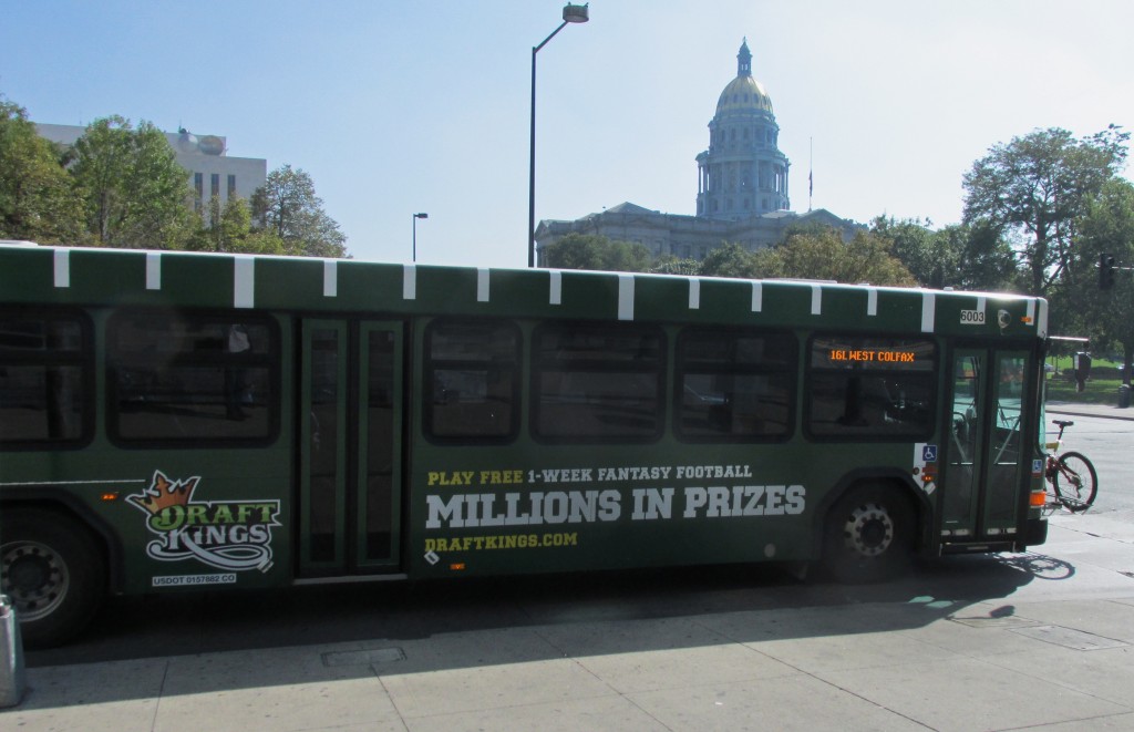 A DraftKings ad-plastered bus drives past the Capitol. Photo by Aaron Kremer.