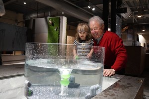 A family experiments with a water exhibit at the museum. 
