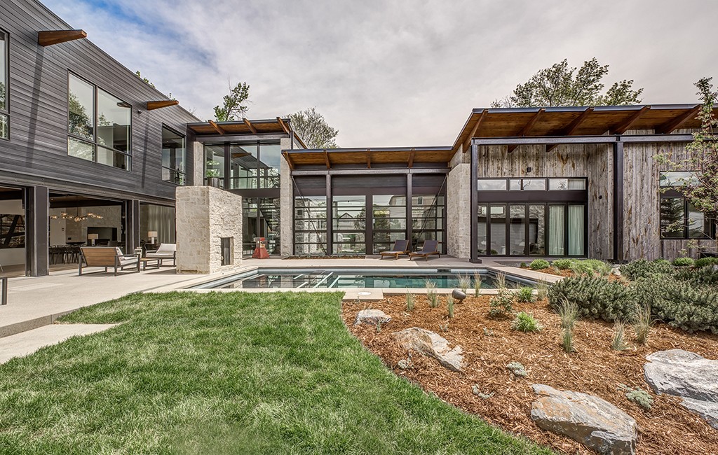 The Cherry Creek home includes a saltwater pool and hot tub, wooden steps climbing up a steel and glass stairway and a rooftop deck. (Courtesy LIV Sotheby's)