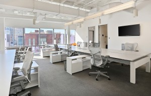 Empty desks and chairs inside the former office of the defunct marketing firm. (Courtesy NAI Shames Makovsky)