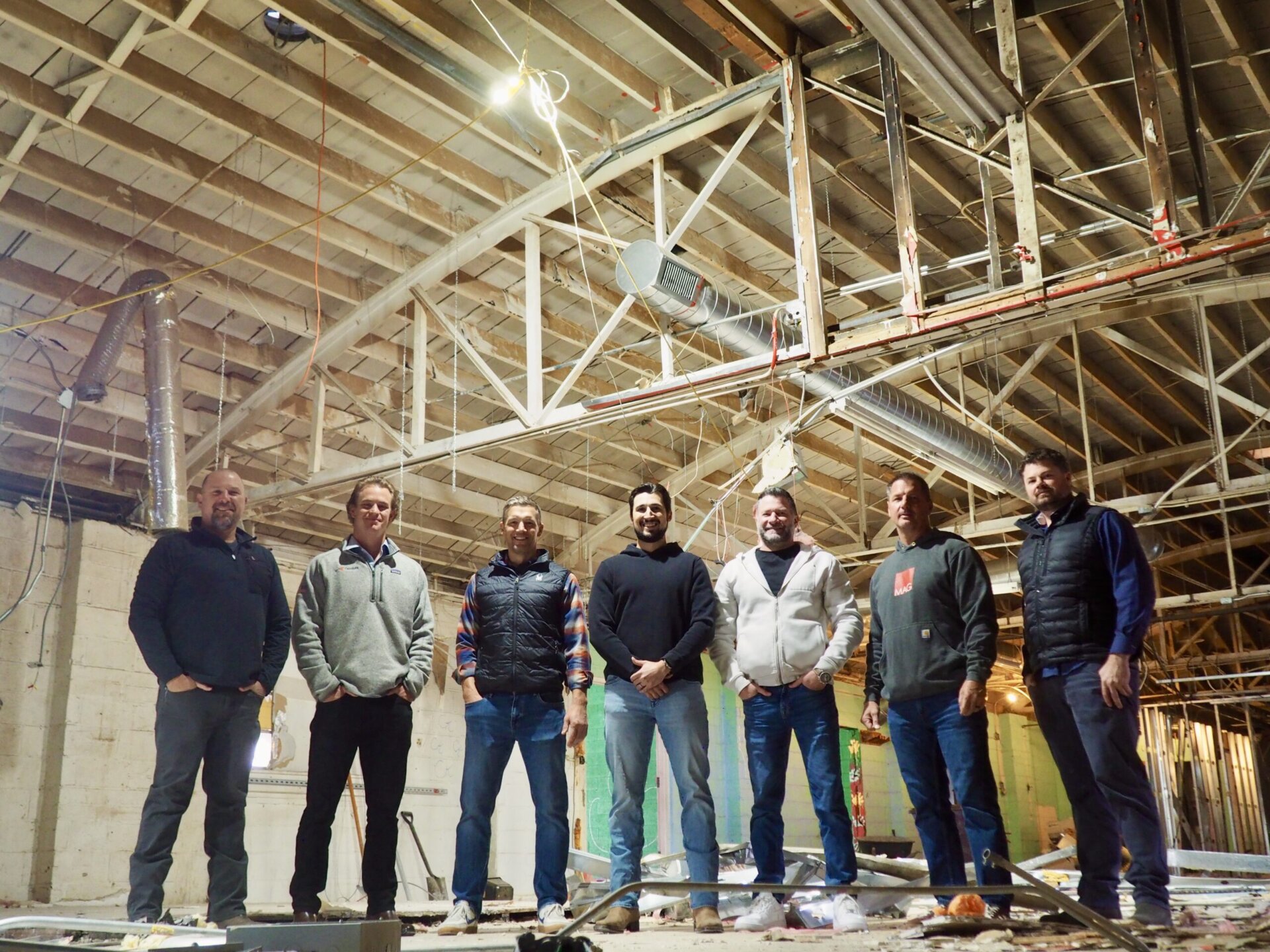 The partners stand together inside their new building. From left, Greg Krom, Will Deines, Christian Hutter, Aaron Horvat, Mike Griger, Mike Moylen and Mike Christensen.