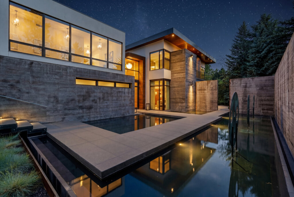 Twilight exterior of 31 Albion Place showing the home's reflecting pool and water feature