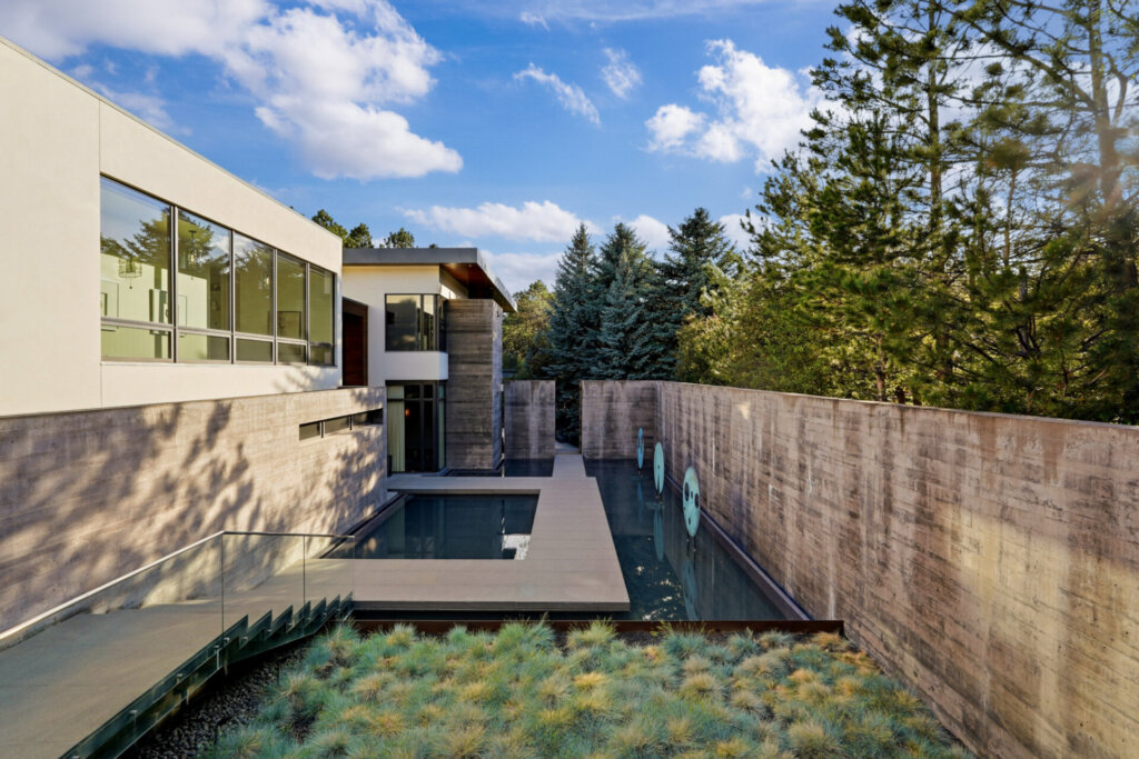 Garden walkway at 31 Albion Place lined with a concrete wall and bronze sculptures