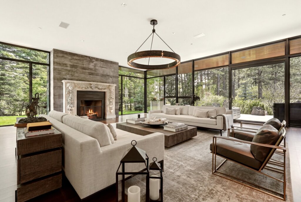 Living room at 31 Albion Place with a stone fireplace and floor-to-ceiling glass walls