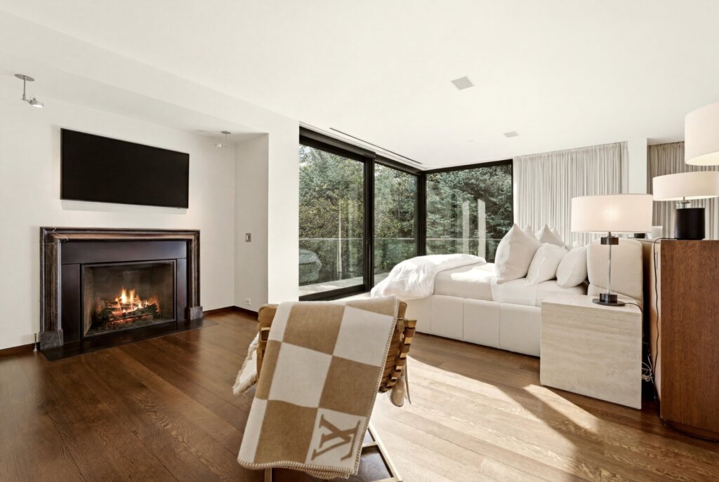 Primary suite at 31 Albion Place with a fireplace and floor-to-ceiling windows
