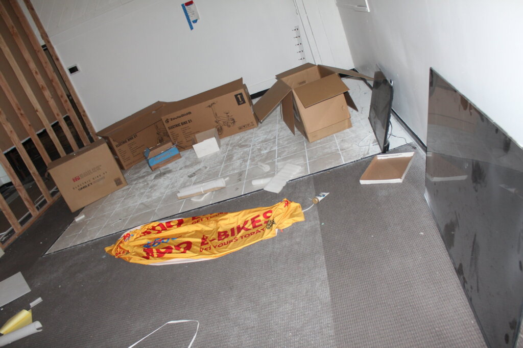Empty bike boxes, left behind TVs and signs inside Bear Trail Bike's former Lakewood location.