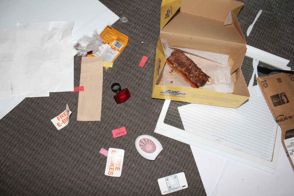 Trash and an old donut left inside Bear Trail Bike's Lakewood location.