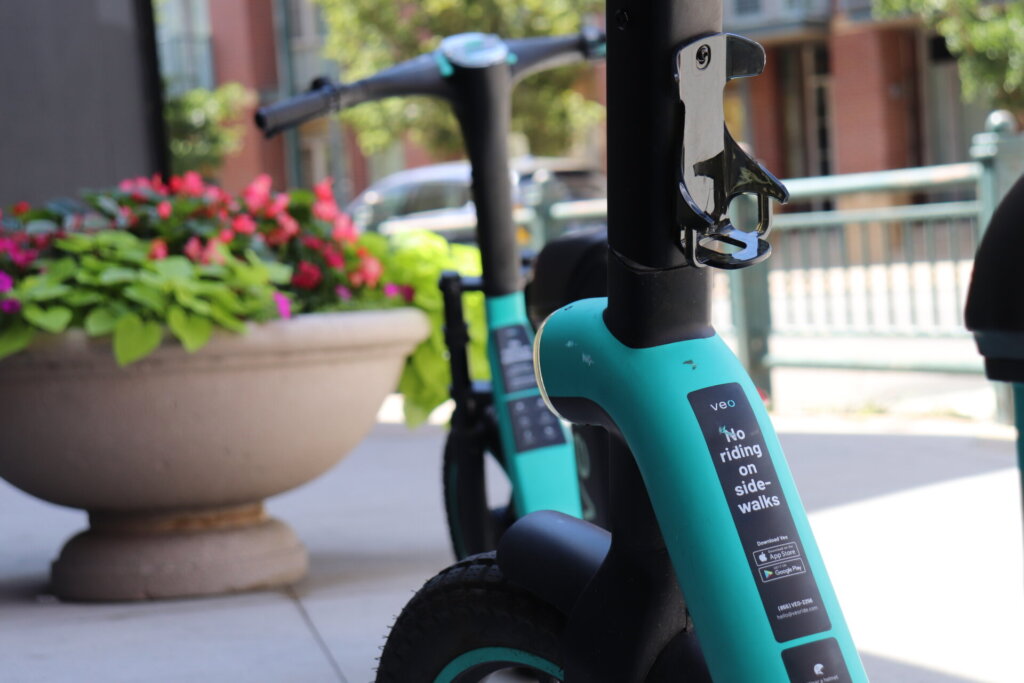 A Veo scooter showing the warning to not ride on the sidewalk.