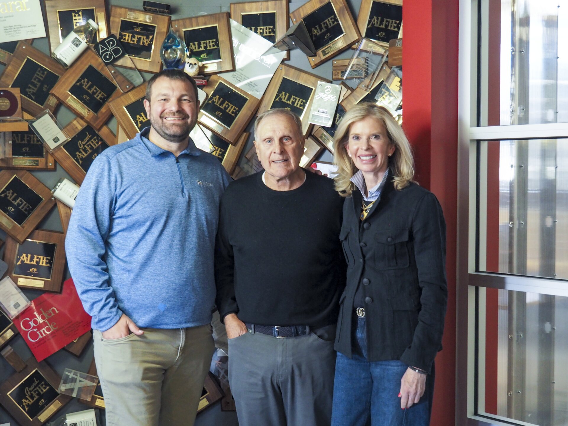Three KHM executives pose for a photo.
