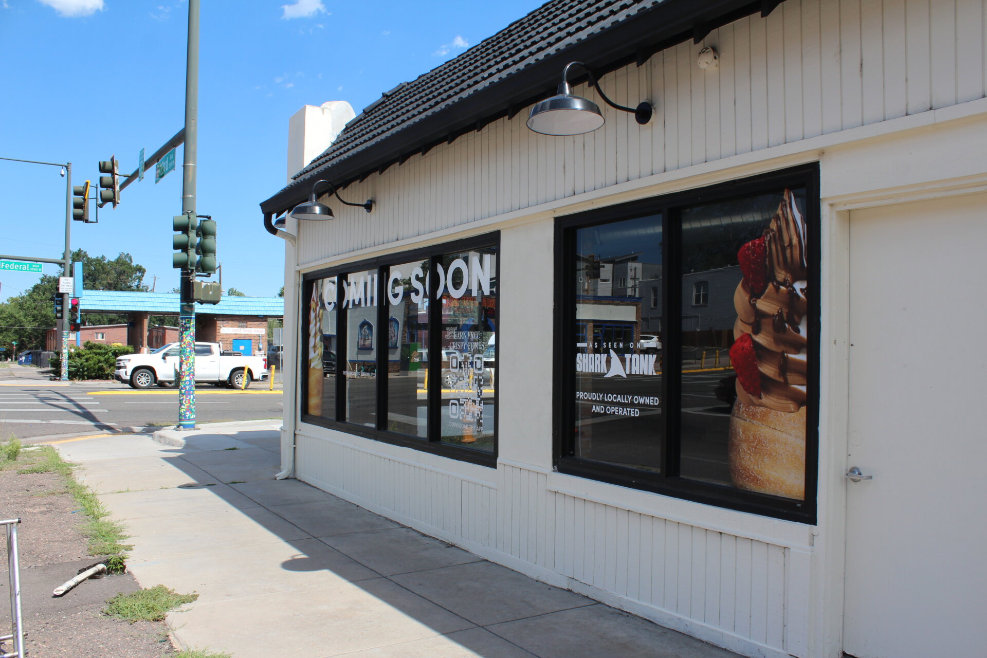Signs outside of 2300 W 23rd Ave that say "Coming Soon" and "As Seen on Shark Tank."