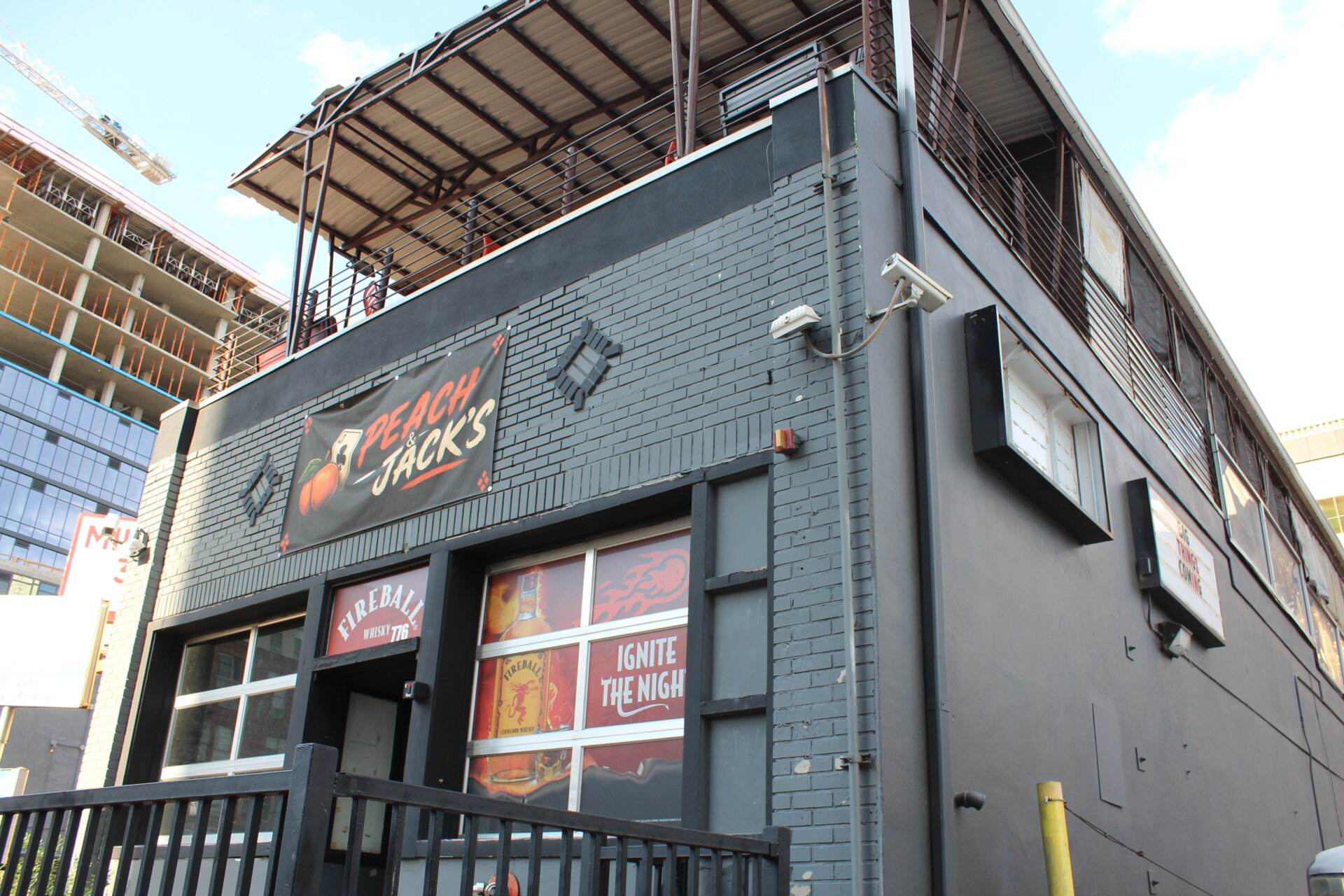 The front facade of Peach & Jack's, with an apartment development behind it