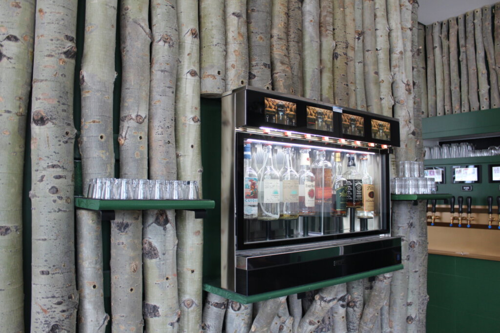 The Aspen trees inside Tapster that surround its tap wall and alcohol selection.